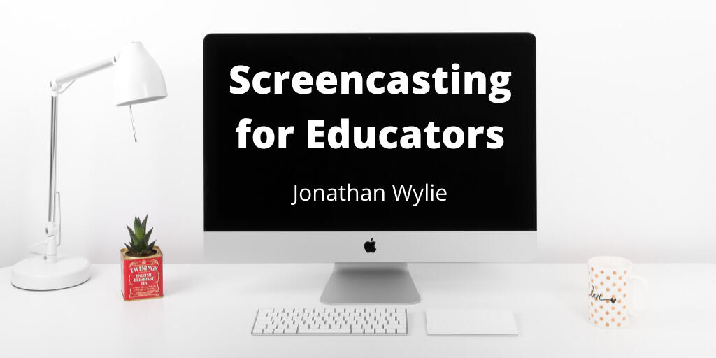 iMac computer on a white desk. Text on screen reads, Screencasting for Educators